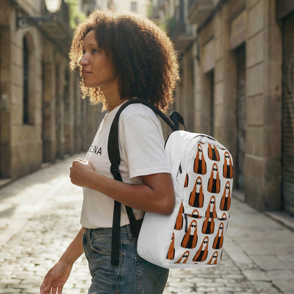 Person walking down a Barcelona sunlit street with a white 'MAGDALENA' pattern backpack.