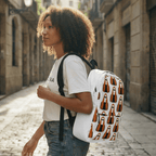 Person walking down a Barcelona sunlit street with a white 'MAGDALENA' pattern backpack.