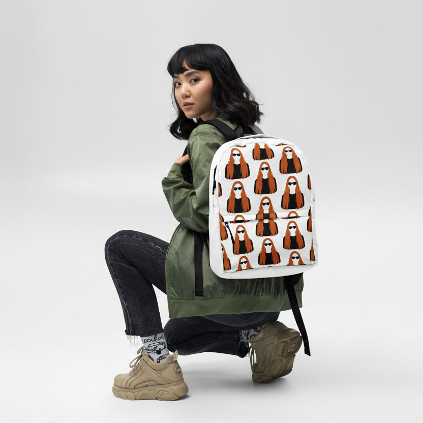 Person wearing a backpack with a 'MAGDALENA' pattern.