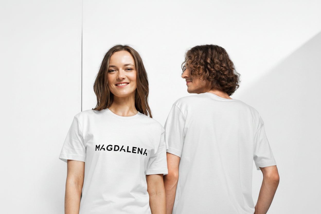 Two people wearing white t-shirts with 'MAGDALENA' printed on them, one facing forward and the other facing backward.